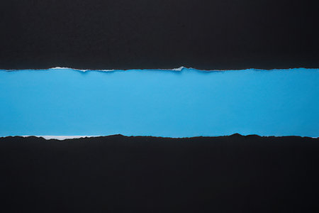 Torn paper with space for your message on a blue background.の写真素材