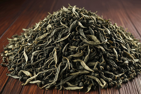 Heap of dry green tea leaves on wooden table, closeupの素材