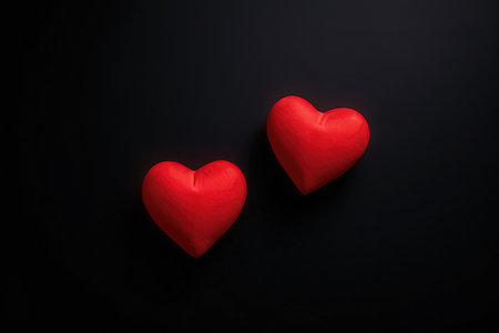 Two red hearts on a black background. Valentines day background.の写真素材