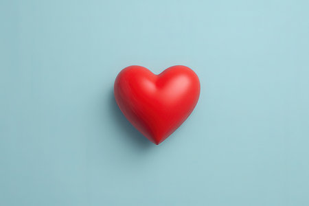 Red heart on blue background. Minimal love concept. Top view.の写真素材