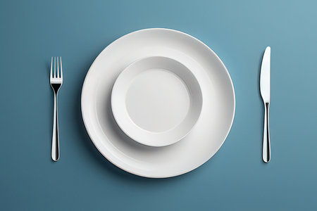 Empty plate, knife and fork on blue background. 3d renderingの写真素材