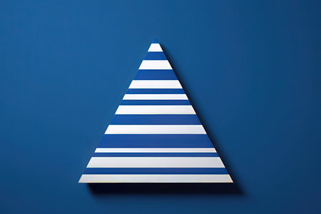 Christmas tree made of striped paper on blue background. Minimal concept.の写真素材