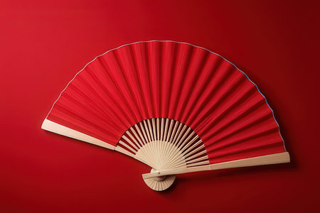 Folding fan isolated on a red background. 3d illustration.の写真素材