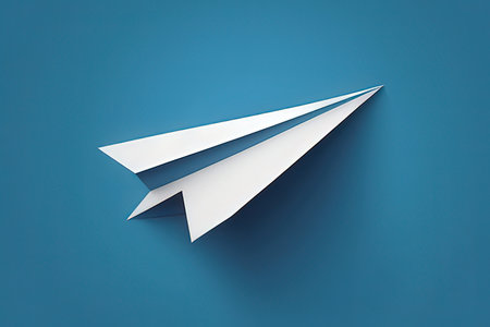 Paper plane isolated on blue background. 3d illustration. Top view.の写真素材