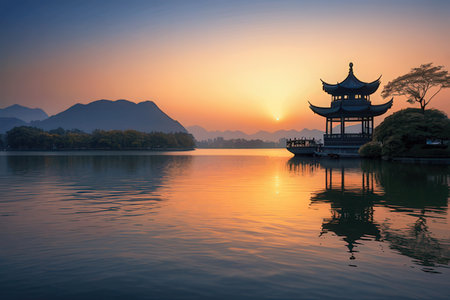 Beautiful landscape with lake and mountain at sunset in Hangzhou, Chinaの写真素材