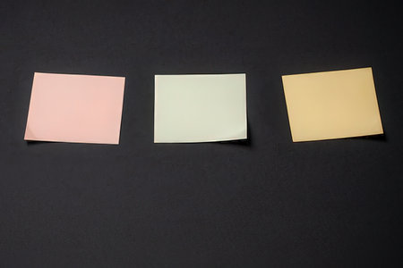 Colorful sticky notes on black background. Copy space for text.の写真素材
