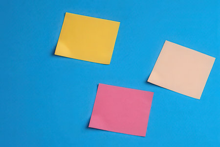 Colorful post it notes on blue background. View from above.の写真素材