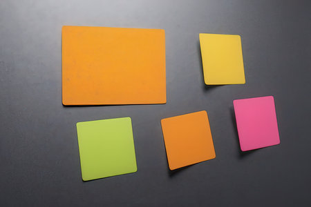 Colorful sticky notes on a black background, close-up.の写真素材