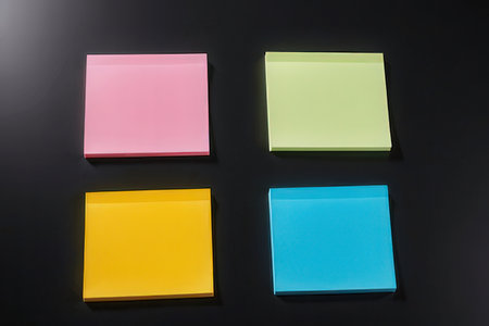 Colorful sticky notes on a black background, closeup of photo