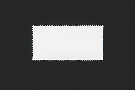 Blank postage stamp on black background, copy space for text.の写真素材