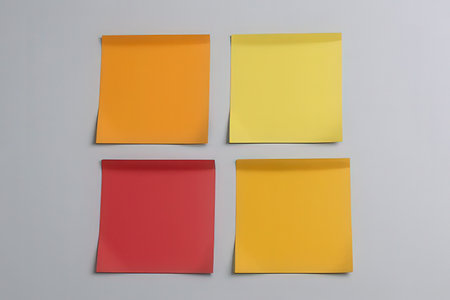Yellow, red and orange sticky notes on a gray background. 3d renderingの写真素材