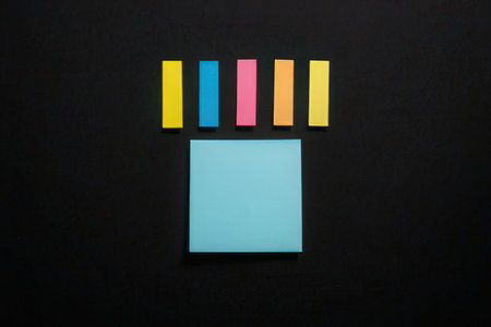 Colorful sticky notes on blackboard background. View from above.の写真素材
