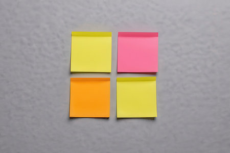 Colorful sticky notes on a gray wall. View from above.