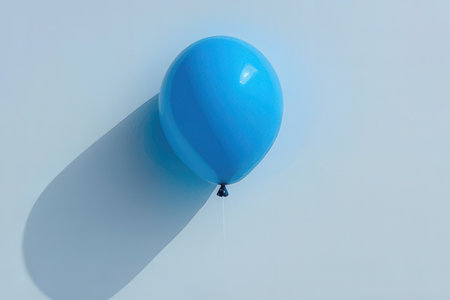 Blue balloon on a blue background. Minimalistic style. Flat lay.の写真素材