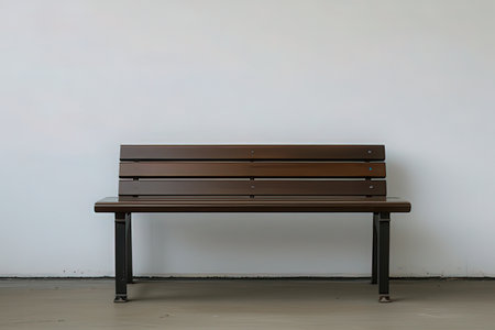 Wooden bench in front of a white wall with copy space.