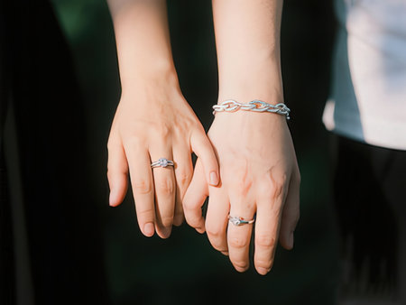 Wedding rings on the hands of the bride and groom.の写真素材