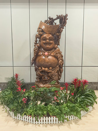 Wooden statue of a Chinese god in the interior of a shopping centerの写真素材