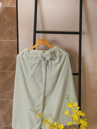 Clothes hanger with flowers on hanger in bathroom, closeupの写真素材