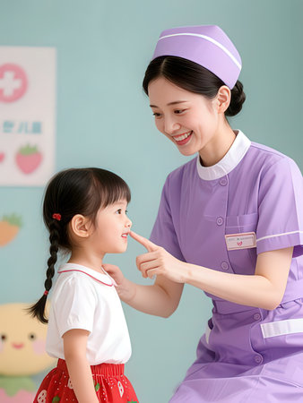 Asian female nurse and a little girl looking at each other with smileの写真素材