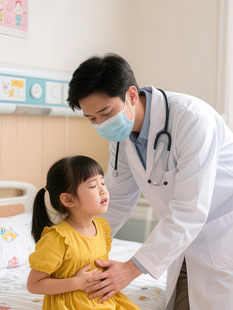 Asian male doctor examining little girl in hospital room. Asian people.の写真素材