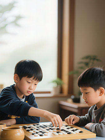 Two little boys playing board game in the living room at home.の写真素材