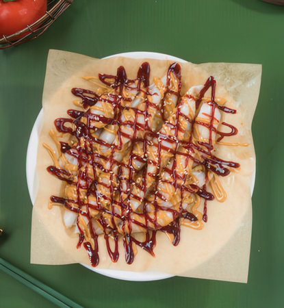 Food with sweet and sour sauce on the green background.