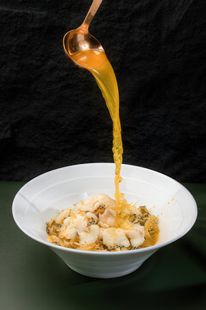 Fried squid with oyster sauce in white bowl on black background
