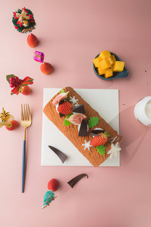 top view of delicious chocolate cake with fruits and berries on pink background