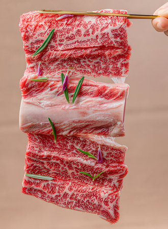 Raw beef sirloin with rosemary on a beige backgroundの写真素材