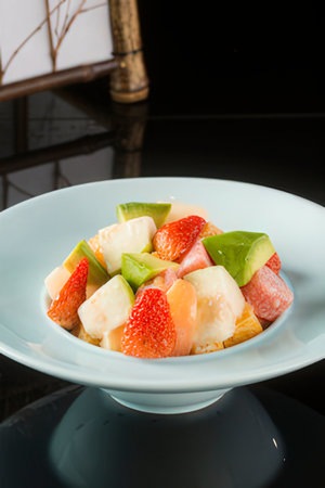 Fruit salad in a dish on the table, close-upの写真素材