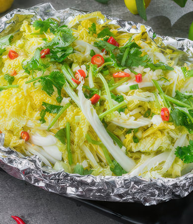 Fried Chinese cabbage with chili and coriander in foil.の写真素材