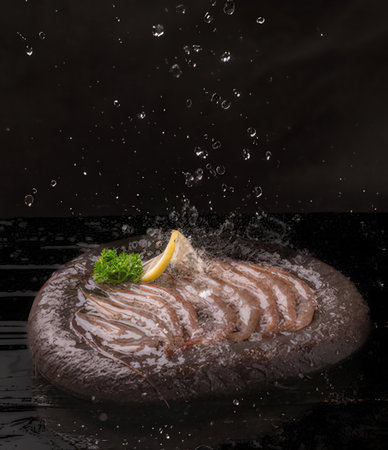 Chocolate Souffle with lemon and parsley on black backgroundの写真素材