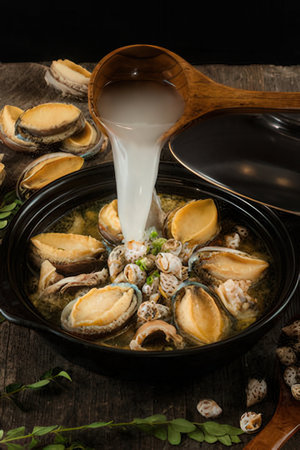 Seafood soup with mussels in a bowl on wooden tableの写真素材