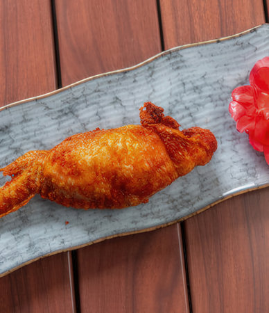 Fried chicken on a plate on a wooden background, top viewの写真素材