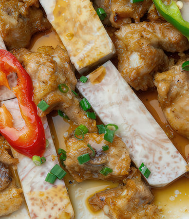 Chinese food, closeup of chicken with rice and vegetables as background