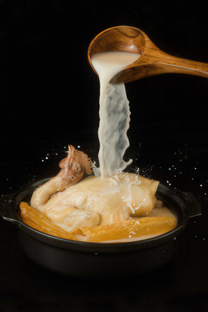 boiled dumplings in a frying pan on a black backgroundの写真素材