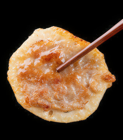 gyoza dumplings with chopsticks on black backgroundの写真素材