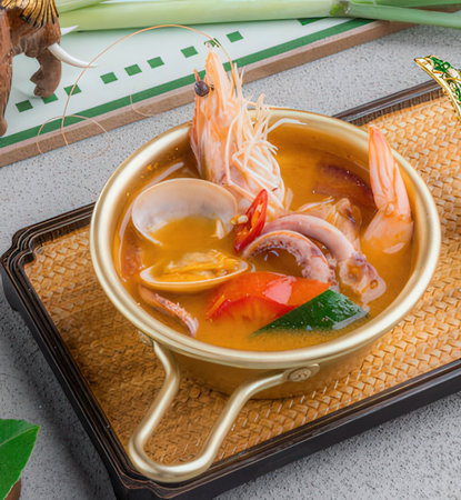 Tom Yum Goong, Thai spicy seafood soup with shrimp and squidの写真素材