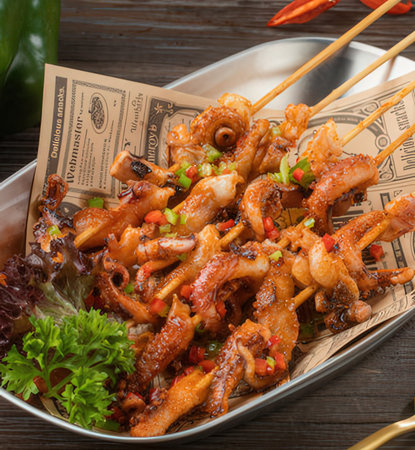 Fried squid with sweet and sour sauce on wooden table, top viewの写真素材