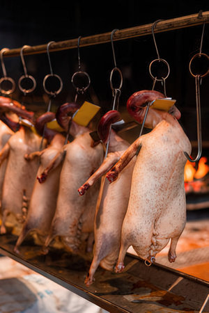 Fresh raw duck meat on a spit in the smokehouse. Close upの写真素材