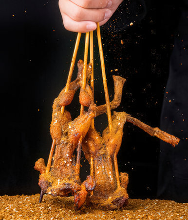 Grilled chicken on a black background.の写真素材