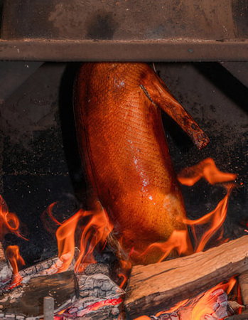 Piece of smoked fish on a fire in a restaurant. Close-upの写真素材