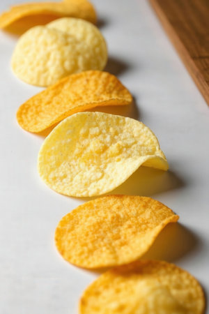 Potato chips on a white background, close-up, selective focus.