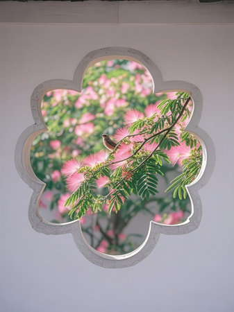 Mirror window with pink flowers and a little bird on it.の写真素材