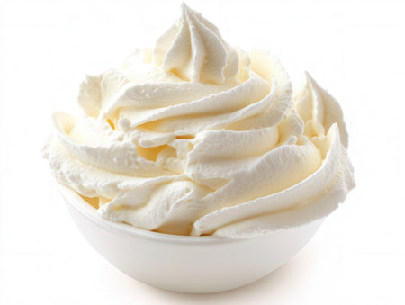 whipped cream in a bowl on a white background. close-upの素材