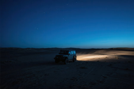 Off-road vehicle in the Sahara desert at night, Morocco.の素材