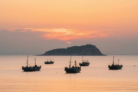 Fishing boats in the sea at sunset in Phuket, Thailandの素材