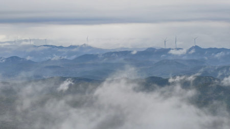 Wind turbines in the fog on a mountain in south korea.の写真素材