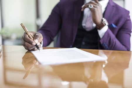African american man signing contract, black man hand putting signature on official document, biracial clients customers couple make purchase or sign prenuptial agreement concept. clouse upの写真素材