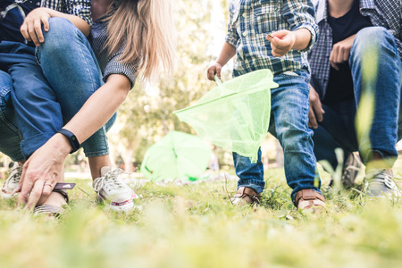 Young happy family fun with children having fun in nature. young parents are resting on a picnic.の写真素材